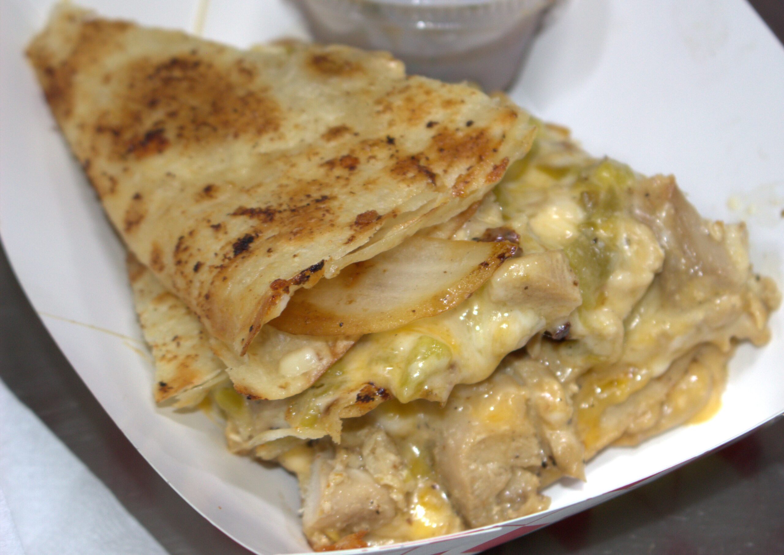 A big, gooey looking, melted cheese, and mouthwatering quesadilla right off the grill
